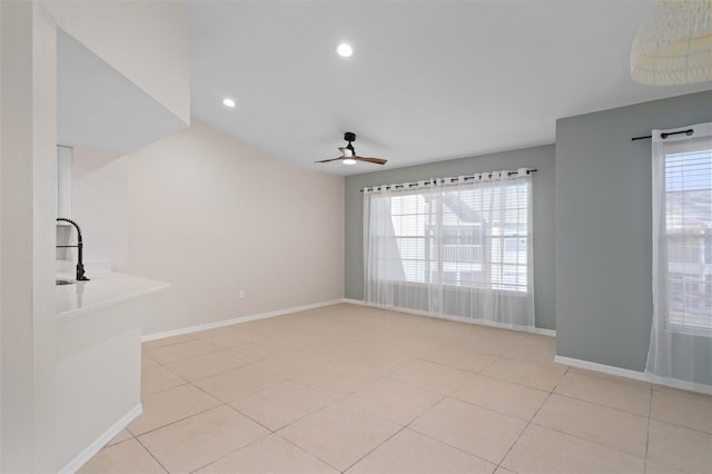 tiled spare room featuring ceiling fan