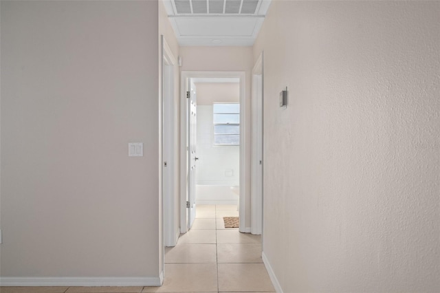 hall featuring light tile patterned floors