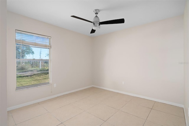 tiled empty room featuring ceiling fan