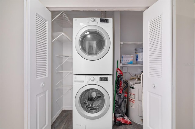 laundry room with dark hardwood / wood-style floors, electric water heater, and stacked washer and dryer