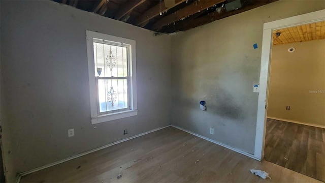 spare room with hardwood / wood-style floors and wood ceiling