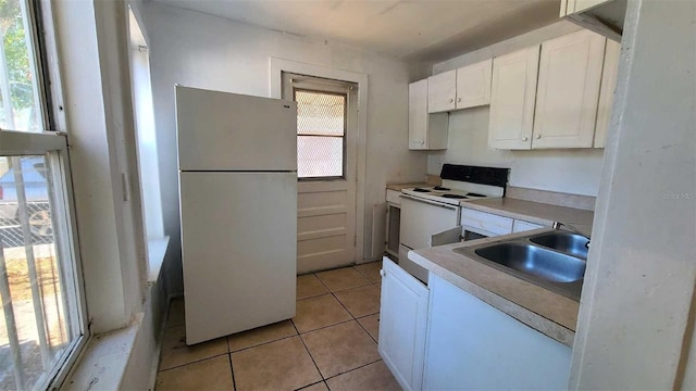 kitchen featuring a wealth of natural light, sink, white cabinets, and white appliances