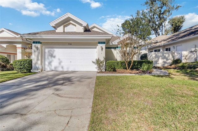 view of front of home with a front yard and a garage