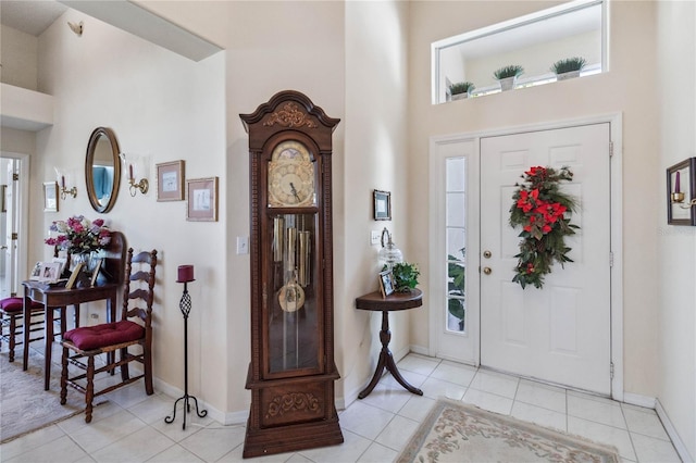 tiled entrance foyer featuring plenty of natural light and a towering ceiling