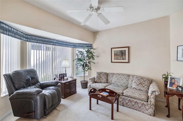 carpeted living room featuring ceiling fan