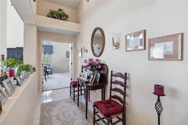 dining space with light colored carpet and a high ceiling