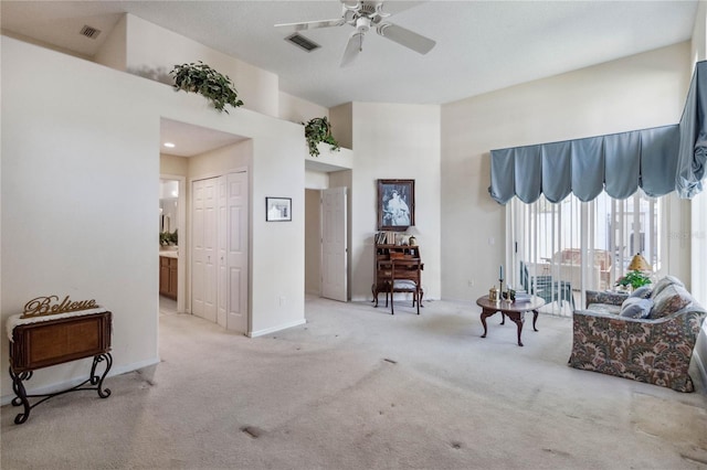 living room featuring light carpet and ceiling fan