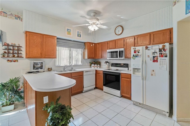 kitchen featuring ceiling fan, sink, kitchen peninsula, white appliances, and light tile patterned flooring