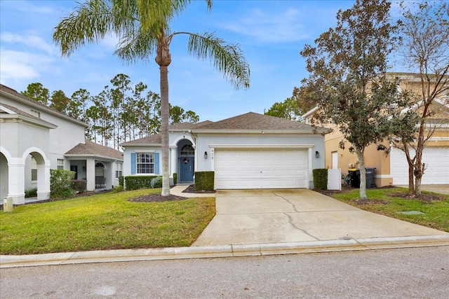 view of front of property featuring a garage and a front lawn