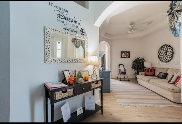 interior space with ceiling fan and wood-type flooring