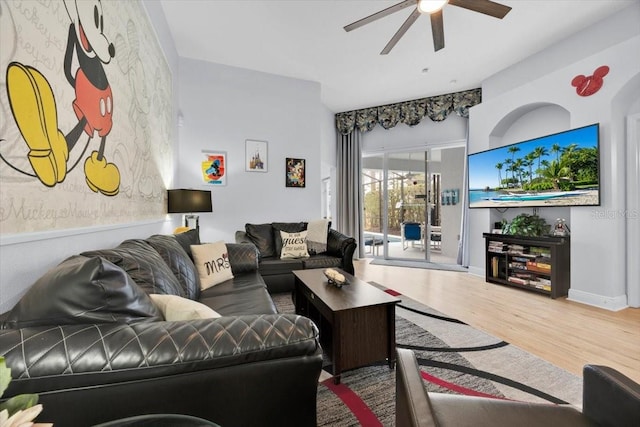 living room featuring ceiling fan and hardwood / wood-style flooring