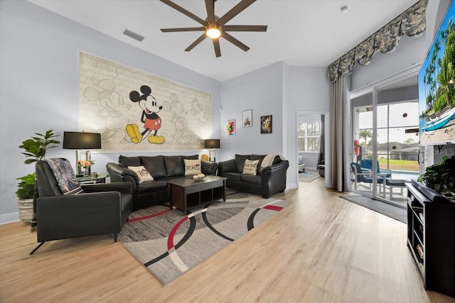 living room featuring ceiling fan and light hardwood / wood-style flooring