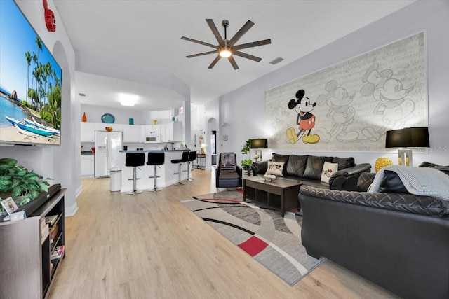 living room with ceiling fan and light hardwood / wood-style floors