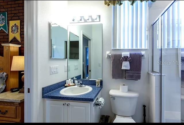 bathroom featuring vanity and toilet