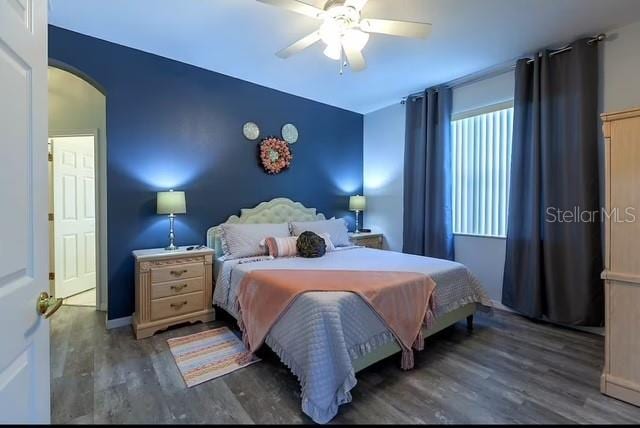 bedroom with ceiling fan and dark wood-type flooring