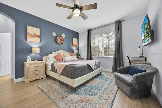 bedroom with ceiling fan and light hardwood / wood-style floors