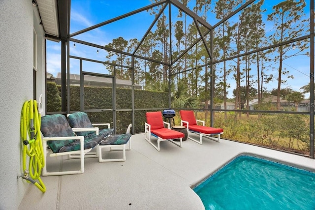 view of swimming pool with glass enclosure and a patio