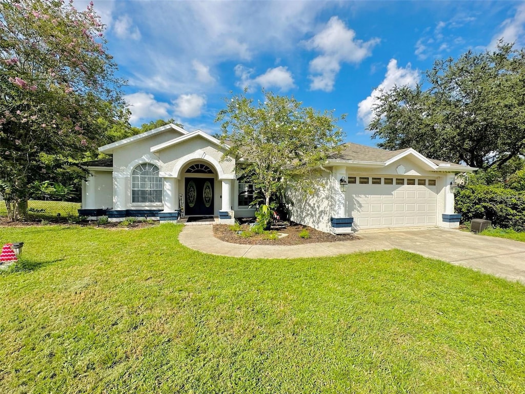 single story home with a garage, a front yard, and french doors