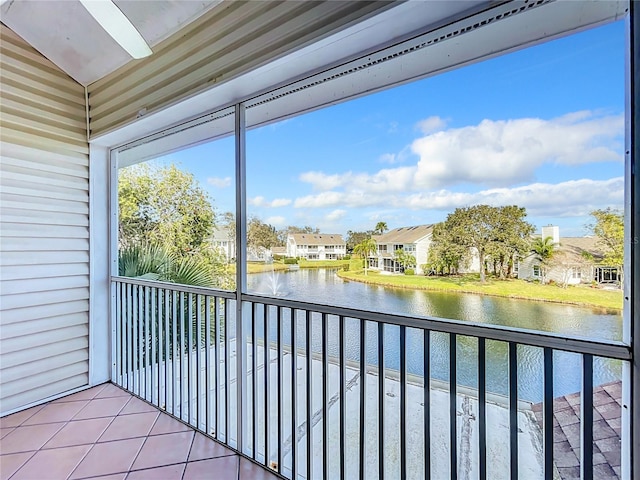 unfurnished sunroom featuring a water view