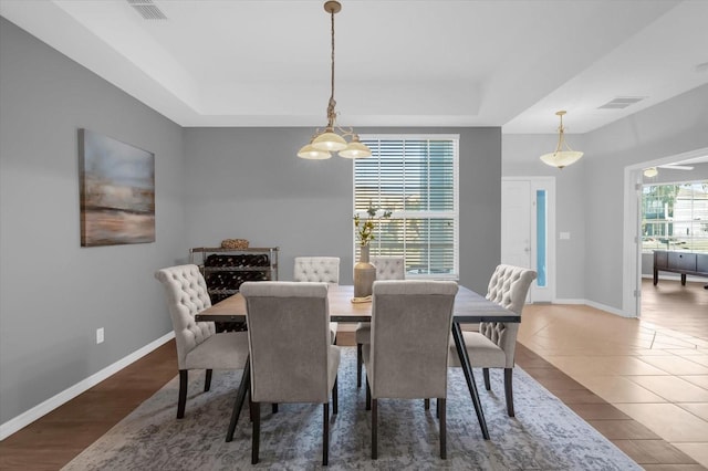 dining area with wood-type flooring and a chandelier