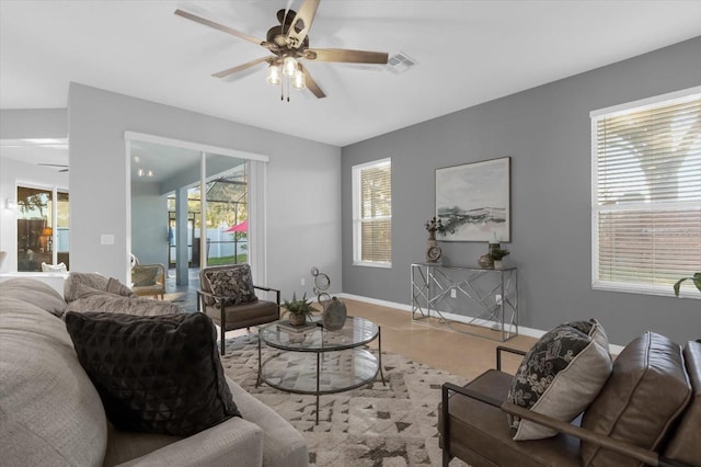 living room featuring ceiling fan and vaulted ceiling