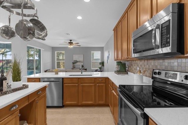 kitchen with decorative backsplash, appliances with stainless steel finishes, a healthy amount of sunlight, and sink