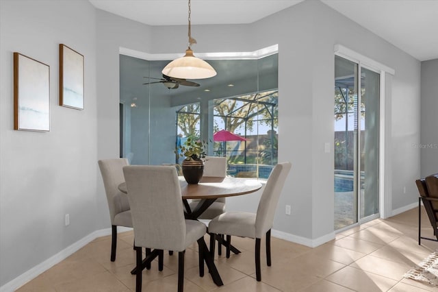 tiled dining space with ceiling fan and a healthy amount of sunlight