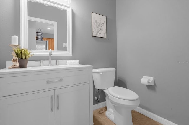 bathroom with tile patterned floors, vanity, and toilet