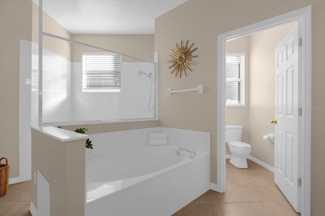 bathroom with tile patterned flooring, shower with separate bathtub, a textured ceiling, and toilet