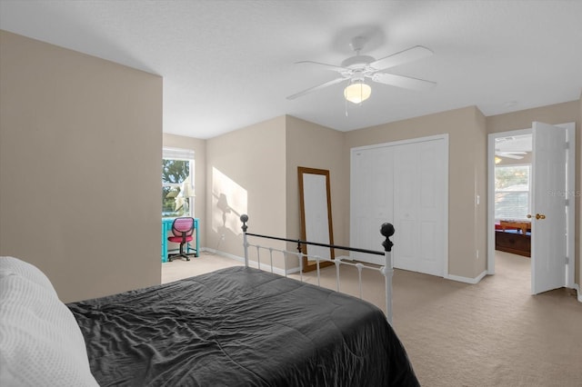 carpeted bedroom with a closet and ceiling fan