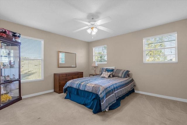 bedroom with light colored carpet and ceiling fan