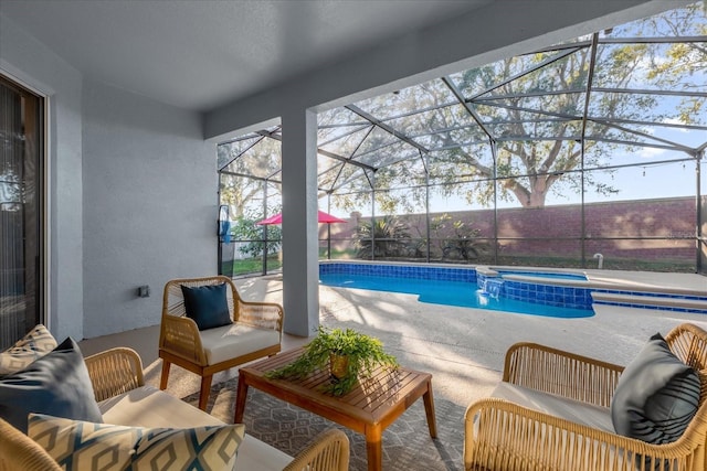 view of swimming pool with a lanai, a patio area, an in ground hot tub, and an outdoor hangout area