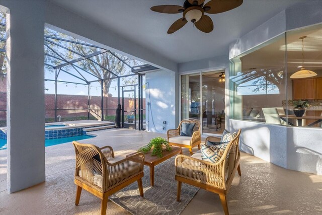 view of patio / terrace with ceiling fan, a swimming pool with hot tub, an outdoor living space, and glass enclosure