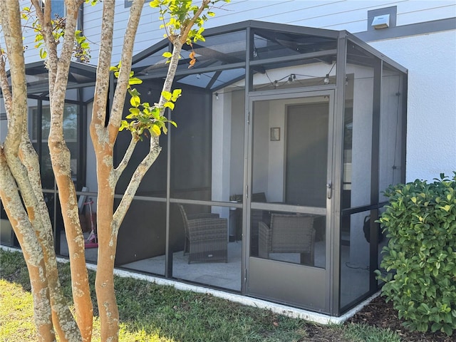 view of exterior entry with a patio