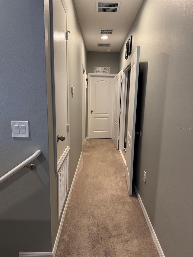 hall featuring light colored carpet