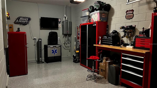 interior space with a workshop area, a garage door opener, and water heater