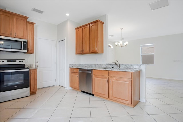 kitchen featuring light stone countertops, sink, an inviting chandelier, light tile patterned flooring, and appliances with stainless steel finishes