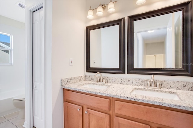 bathroom with tile patterned floors, vanity, and toilet