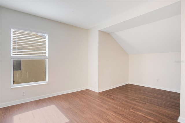 bonus room with plenty of natural light, vaulted ceiling, and hardwood / wood-style flooring