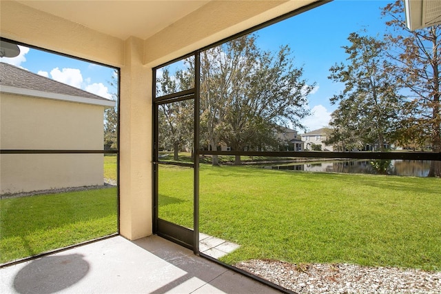 unfurnished sunroom with a water view