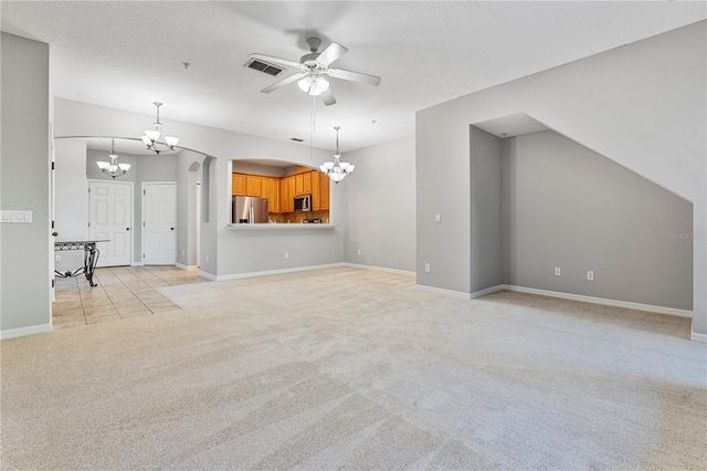 unfurnished living room with ceiling fan, light carpet, and a textured ceiling