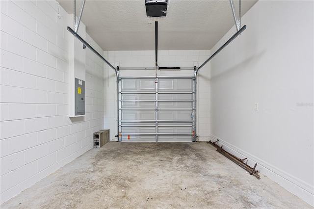 garage with a garage door opener and electric panel