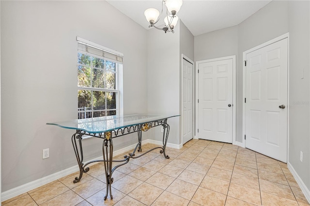 dining room with light tile patterned floors and a chandelier