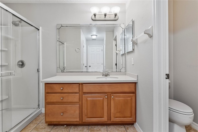 bathroom with tile patterned floors, vanity, toilet, and an enclosed shower