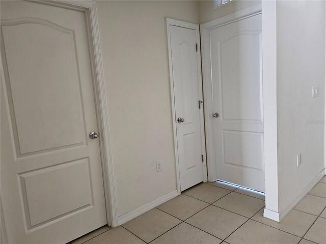 hallway with light tile patterned flooring