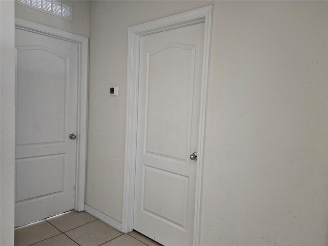 hallway with light tile patterned flooring