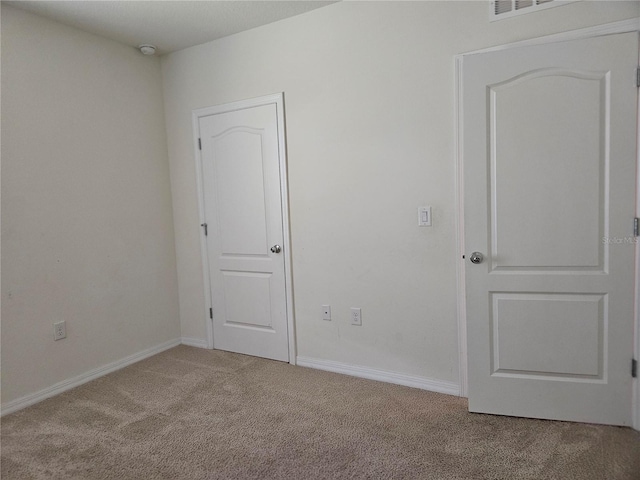 empty room with light colored carpet