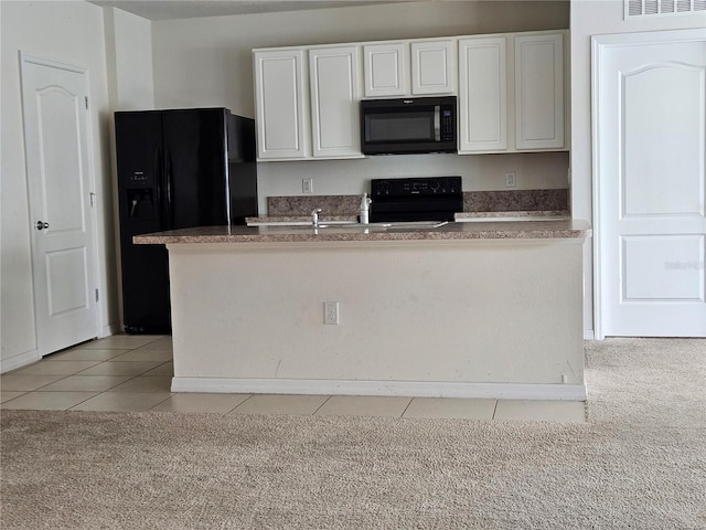 kitchen featuring white cabinetry, light colored carpet, and black appliances