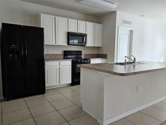 kitchen featuring sink, white cabinets, black appliances, and light tile patterned floors