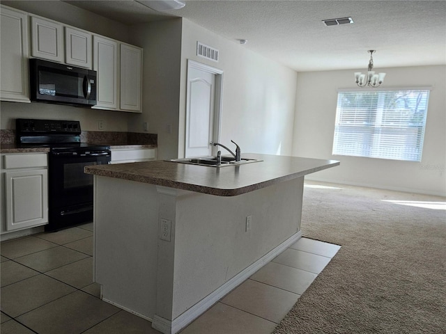 kitchen with white cabinets, sink, a kitchen island with sink, and black / electric stove